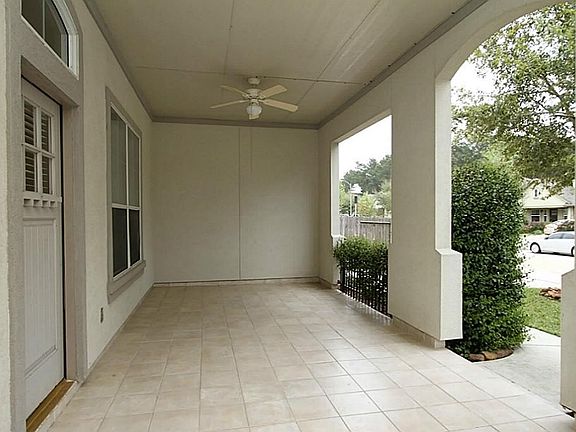 ...an enormous covered front porch that measures 30" x 12", custom tile flooring, two porch fans...