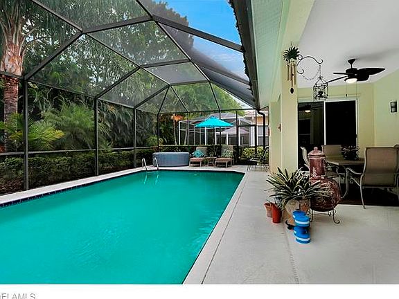 Pool with hot tub, landscaped back yard.