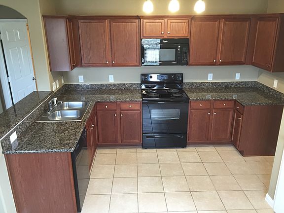 Kitchen with granite counter tops and tile flooring