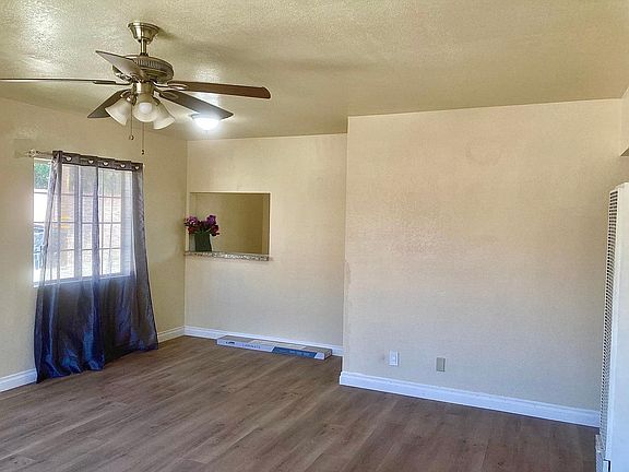 View of living room with fan lamp, great breeze through 2 windows
