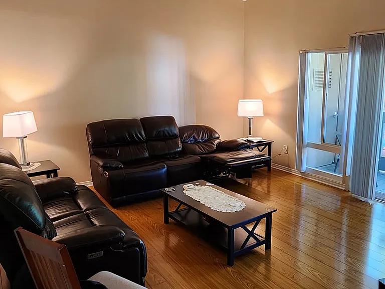 Family room with vaulted ceiling and a balcony with pool view