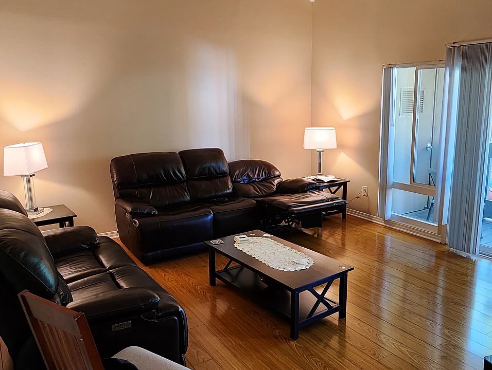 Family room with vaulted ceiling and a balcony with pool view