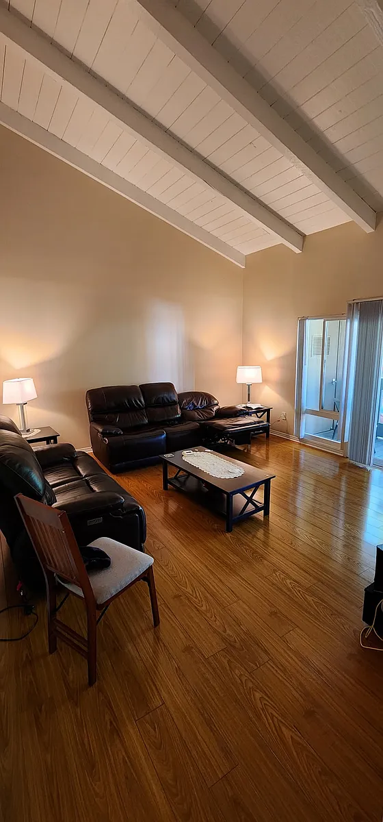 Family room with vaulted ceiling and a balcony with pool view - 17151 W Bernardo Dr W #208