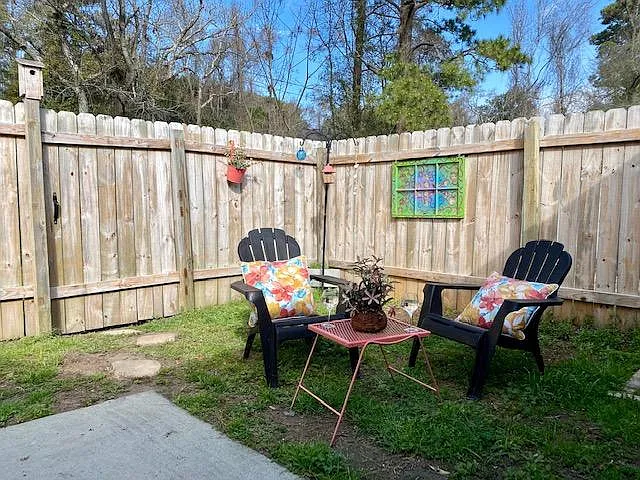Newly-installed fencing around large enclosed patio. Utility shed (not shown in picture) includes beach chairs and large/small coolers. There is also a large pet cage available, if needed, inside the shed. Outdoor Table & Chairs.