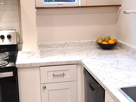 Shaker cabinets, stone-patterned laminate counters