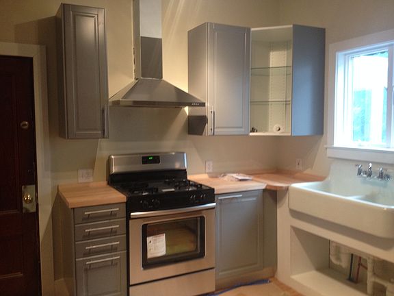 All new stove and hood and antique farm sink. Note: Some cab