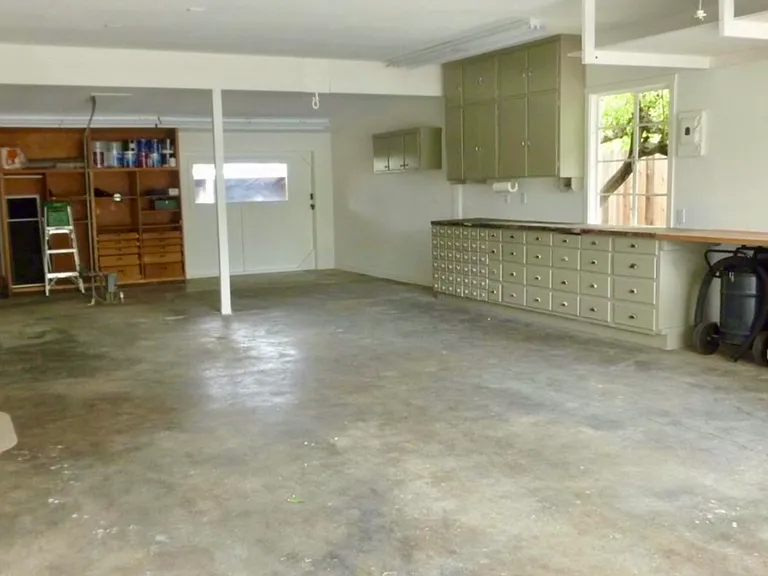 Garage with Barn door leading to outdoor shed