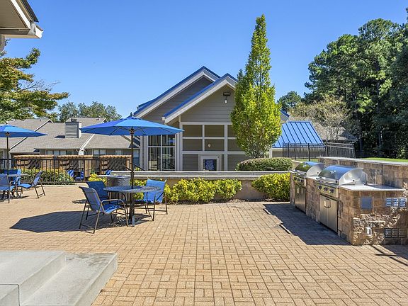 Outdoor entertainment space that's outfitted with a grilling station and abundant seating.