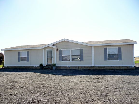 Front of the house with a large driveway
