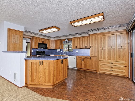 Updated kitchen with custom cabinets and Corian counters. 