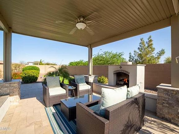 Gas fireplace and cozy gathering spot behind the pool