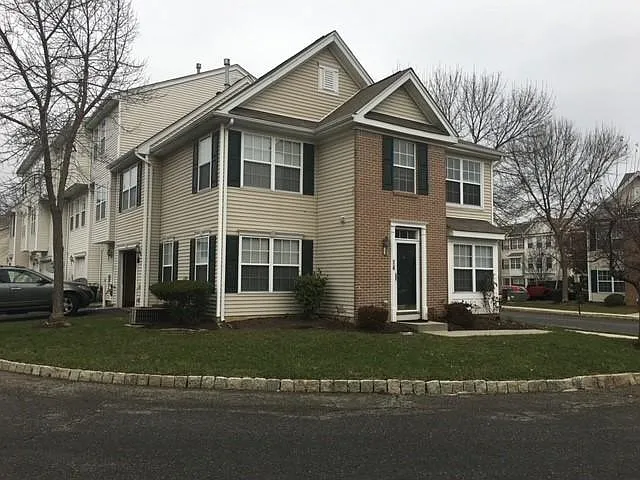 Main Entrance and view of the Garage Door to the left along with the parking slip.