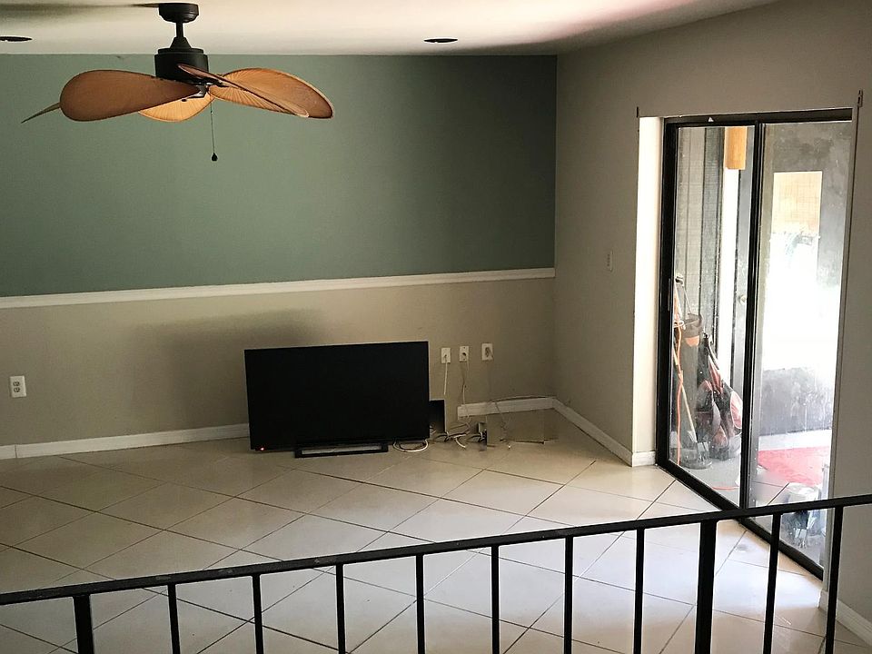 Living Room with sliders to the back screened in Porch