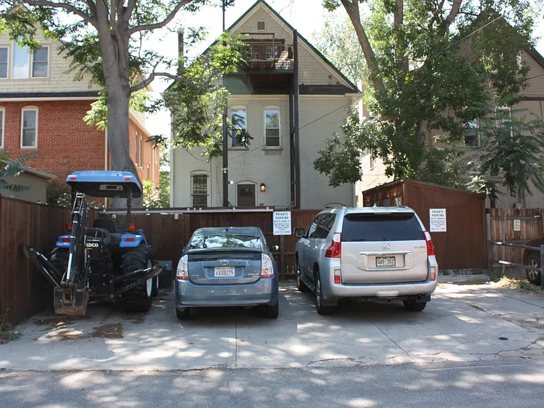 Back of house with 4 parking spots