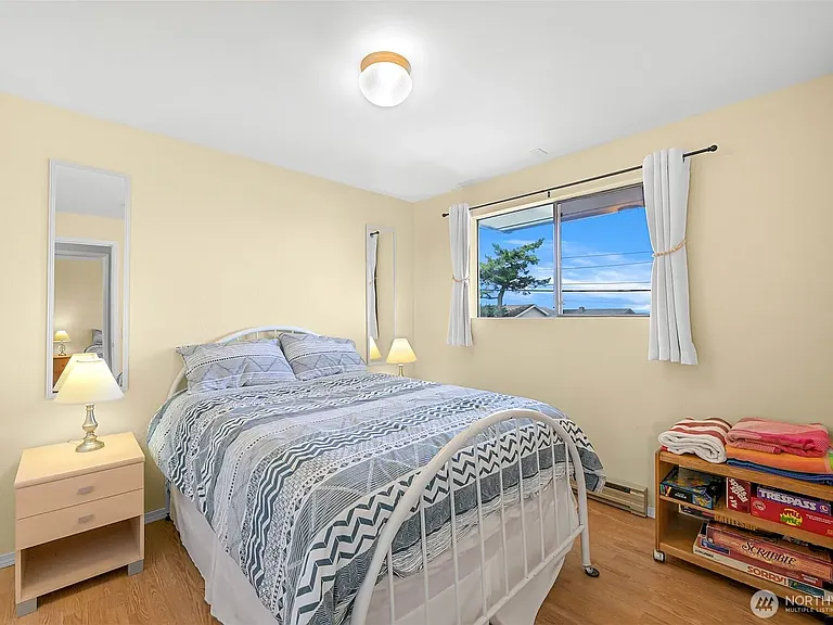 Double bed on main floor. Two bedside tables with lamps.