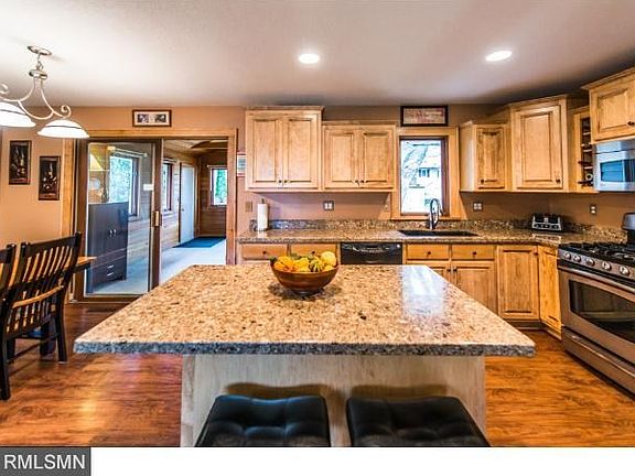 Upper cabinets are Staggered heights and depths, several pull-out drawers in the base cabinets and island. Hidden garbage and recycling in island too.