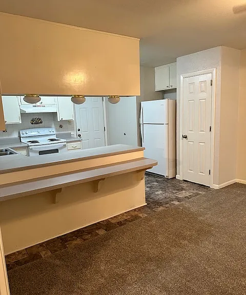 View from entrance to bonus room into dining room and kitchen.