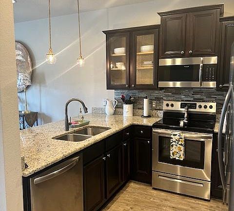 Kitchen with stove, microwave, dishwasher and fridge/freezer