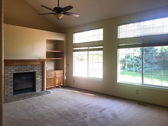 Large family room with vaulted ceilings, built-ins and fireplace.