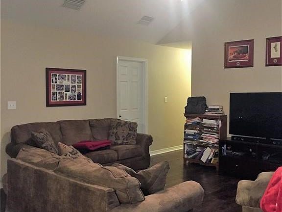 Living Room boasts 12.5' vaulted ceiling and gas fireplace