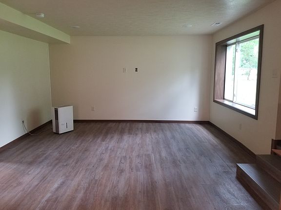 Main floor living area. Curtain rod will be installed upon move in.