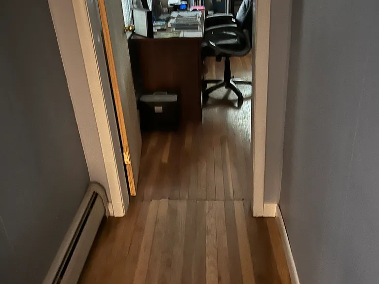 Hallway connecting living room and 1st large bedroom