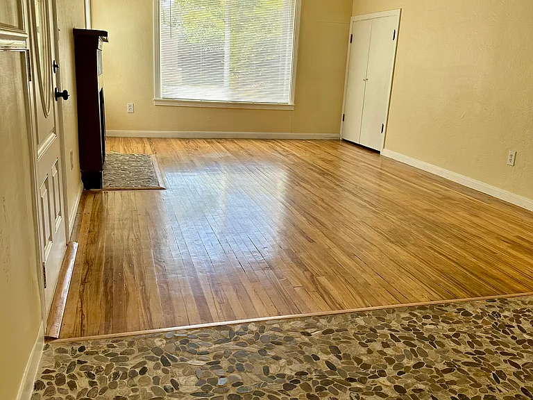 Living room w/ fireplace and storage.