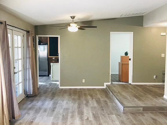 Living room area with 2 pocket doors that separate the kitchen/den/south wing bedrooms.