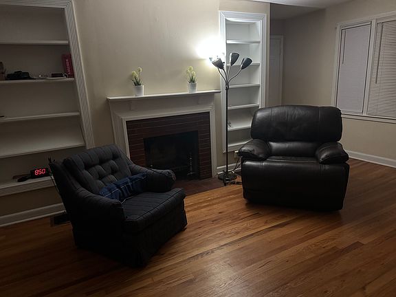 Livingroom with built-in bookshelves and wood burning fireplace.
