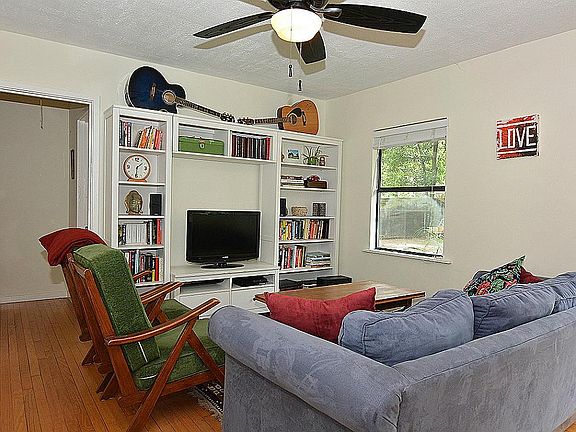 The Living room overlooks the backyard and just as cute as a button