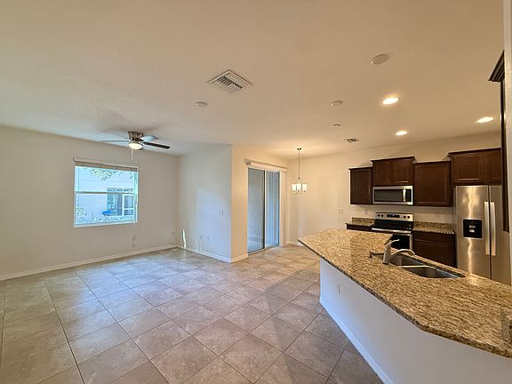 Living space to the left, dining area in the middle and kitchen to the right