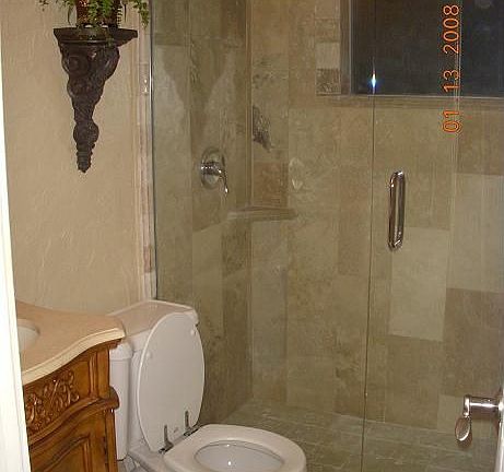 Guest Bathroom with Travertine Shower and Hingeless Glass