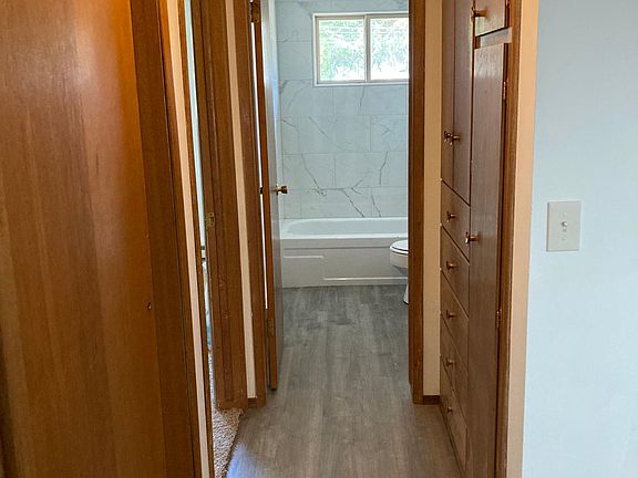 Hallway into bathroom with lots of storage