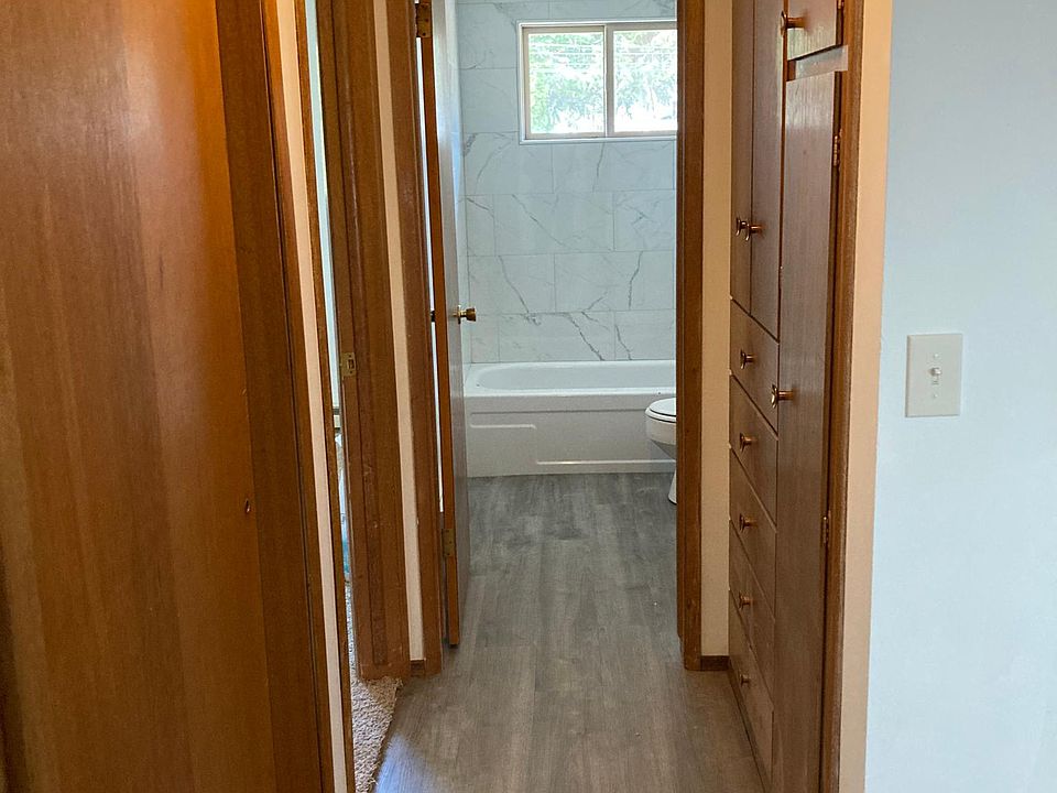 Hallway into bathroom with lots of storage