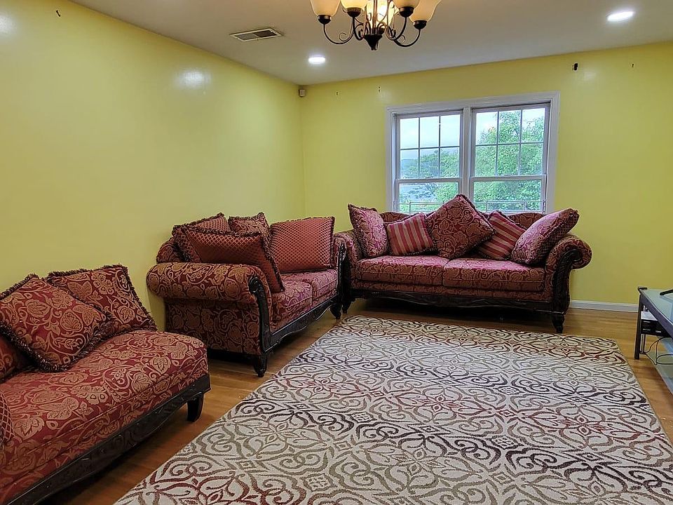 Living room with luxurious Sofa, Love Seat and Lounger with huge Samsung 4k smart tv and ceiling lighting and chandelier
