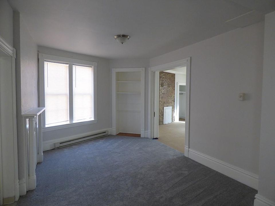 Living room with decorative fireplace and built in shelf