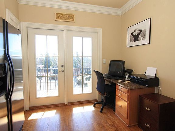 Built-in desk matches the kitchen cabinetry and is bathed in natural light.