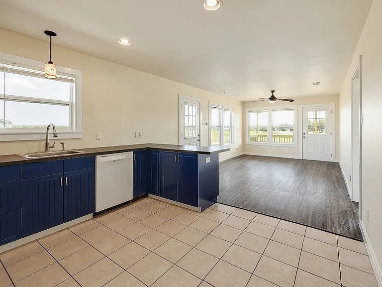 Standing at the closet door in the kitchen looking back into the living space over the bar top.