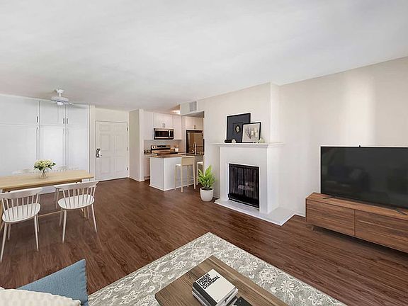 Renovated Package I kitchen, dining, and living area with hard surface flooring