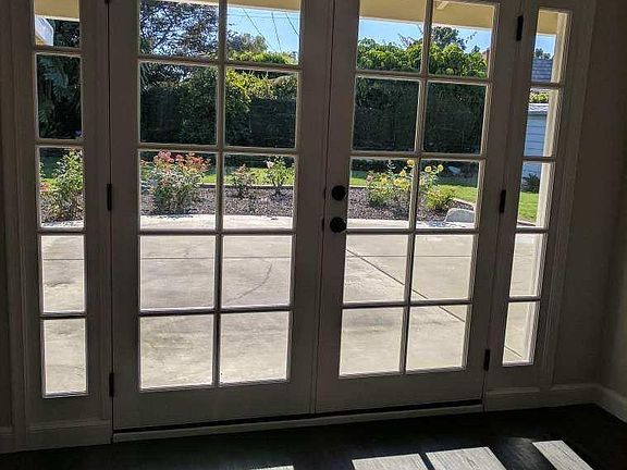French doors invite you into the well manicured backyard.