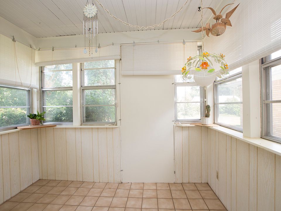 Lovely sun room or mud room has a ceramic tile floor.  Door panel can be easily removed to reveal a glass storm door.