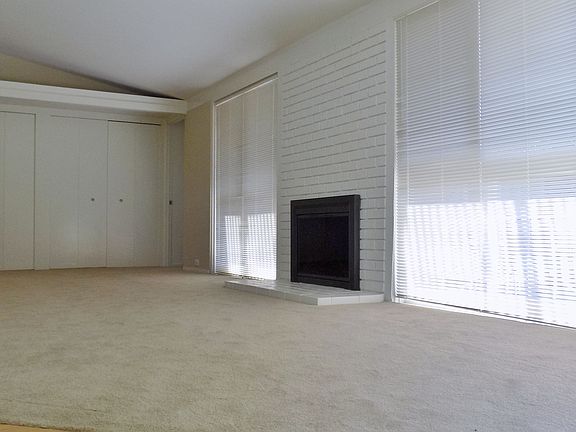 Living room with fireplace open to private side yard