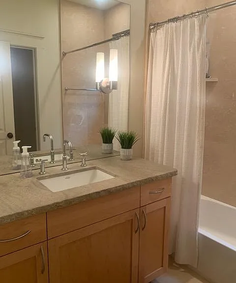 Large downstairs full bathroom with shower and bathtub