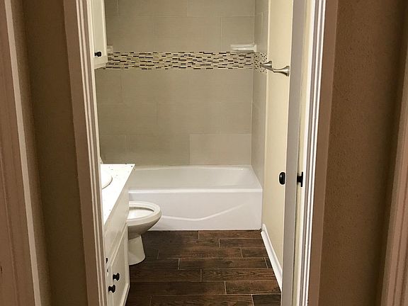 full bath with quartz counters and new tub and tile, light, 