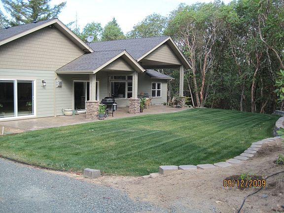 Back yard, big stamped concrete patio with can lights and ceiling fan