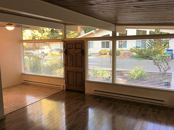 Large, double pane picture windows with wood blinds
