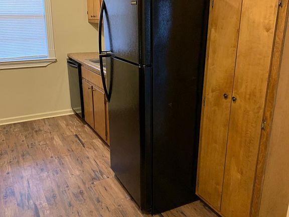Brand new black Frigidaire appliances including refrigerator, dishwasher, and stove.