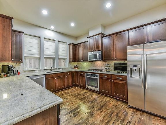 Granite counter tops, stainless steel appliances, numerous cabinets offering a large amount of storage space.