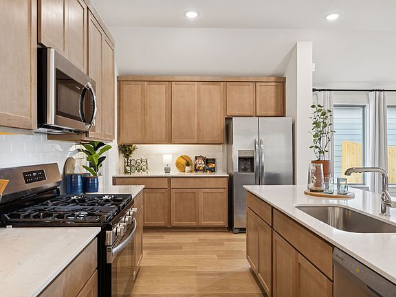 Kitchen in the Diamond home plan by Trophy Signature Homes - REPRESENTATIVE PHOTO