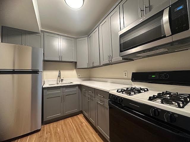 New cabinets, quartz counters, new stainless microwave and refrigerator